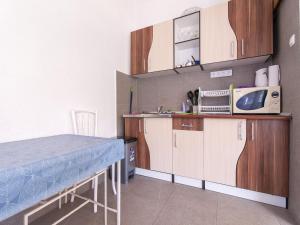 a kitchen with a table and a microwave at Comfort Apartment with Sea View in Neum