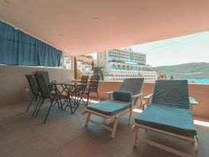 a balcony with chairs and a table and a cruise ship at Comfort Apartment with Sea View in Neum