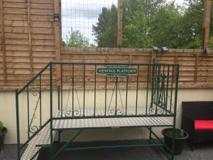 a gate with a sign that reads swinging infantry at The Station Master's Office in Loftus