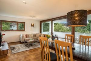 a dining room and living room with a table and chairs at Ferienwohnung Felix in Bregenz