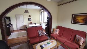 ein Wohnzimmer mit zwei roten Sofas und einem Tisch in der Unterkunft Smestaj Vanja in Arilje