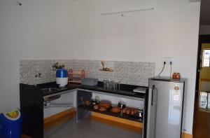 a kitchen with a sink and a refrigerator at Valley View Igatpuri in Igatpuri