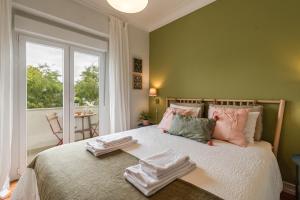 a bedroom with a bed with towels on it at Casa do Restelo in Lisbon