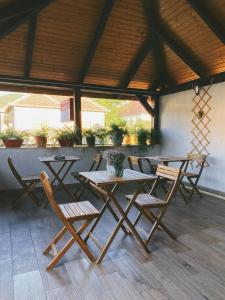 a group of tables and chairs on a patio at Pensiunea Aurelia in Şiria