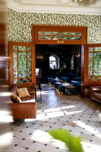 a bar with couches and chairs in a room at Boutique Hotel Krone München in Munich