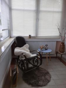 a room with a rocking chair in front of a window at Pusteblume in Hain