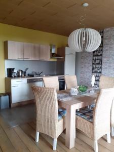 a kitchen with a wooden table and chairs at Pusteblume in Hain