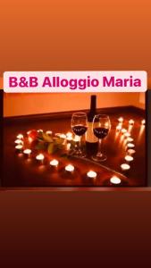 two glasses of wine on a table with lights at B&B Alloggio Maria in Naples