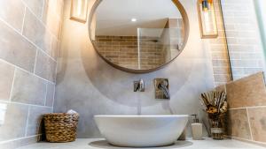 a bathroom with a white sink and a mirror at Palazzino d Irene in Rethymno Town +65 photos