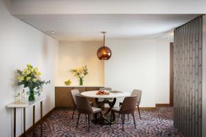 a dining room with a table and chairs at Grand Hotel Millennium Sofia - The Most Spacious Rooms in Sofia, Secured Underground Parking in Sofia