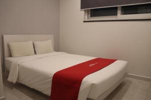 a white bed with a red blanket on it at Hotel Unique by Foret in Seoul