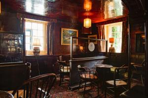 a room with chairs and a table and a window at The Pheasant Inn - The Inn Collection Group in Bassenthwaite