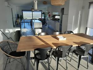 a dining room with a wooden table and chairs at Cairnvillas - Villa Solar C37 Luxury Villa with Swimming Pool near Beach in Aljezur
