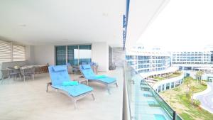 Un balcón con sillas azules en un edificio en Sueno Hotels Deluxe Belek, en Belek