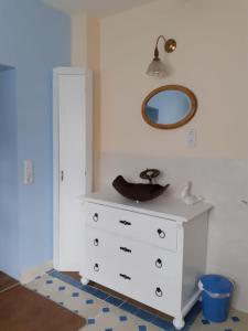 a white dresser with a sink and a mirror at Pusteblume in Hain