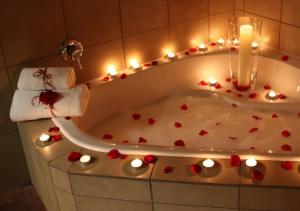 a bath tub with hearts and lights in it at Orange-Ville Lodge & Guesthouse in Stellenbosch