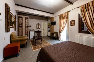 a hotel room with a bed and a living room at Ξενώνας Γούσιας in Ioannina