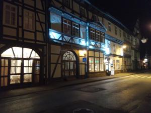 a building with blue lights on a street at night at Hotel Corveyer Hof in Höxter