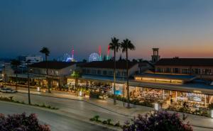 a view of a shopping center at night at Napa Plaza Hotel (Adults Only) in Ayia Napa