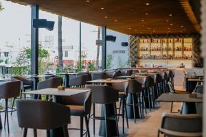 a row of tables and chairs in a restaurant at Napa Plaza Hotel (Adults Only) in Ayia Napa