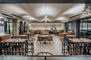 a restaurant with tables and chairs in a room at Napa Plaza Hotel (Adults Only) in Ayia Napa