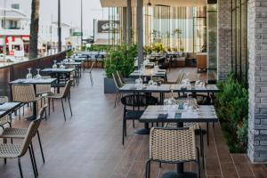 a row of tables and chairs in a restaurant at Napa Plaza Hotel (Adults Only) in Ayia Napa