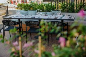 a table with chairs and wine glasses on it at Napa Plaza Hotel (Adults Only) in Ayia Napa