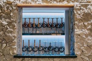 a window in a stone wall with a bunch of scissors at Napa Plaza Hotel (Adults Only) in Ayia Napa