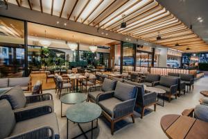 a restaurant with couches and tables and chairs at Napa Plaza Hotel (Adults Only) in Ayia Napa