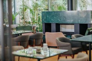 a restaurant with tables and chairs and a fireplace at Napa Plaza Hotel (Adults Only) in Ayia Napa