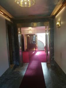 a hallway with a red carpet in a building at Stockholm Classic Budget Hotell in Stockholm