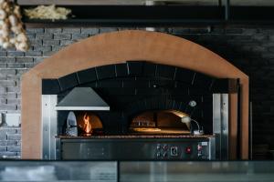 a large brick oven with a fire in it at Napa Plaza Hotel (Adults Only) in Ayia Napa