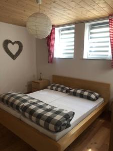 a bedroom with two beds and a heart on the wall at Ostallgäu in Ruderatshofen
