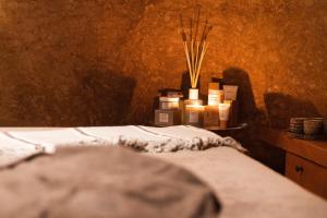 a room with a bed with a bunch of candles at Paragon 700 Boutique Hotel & SPA in Ostuni