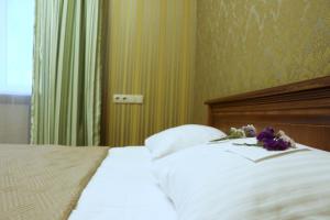 Postel nebo postele na pokoji v ubytování Bogdanov Yar Hotel