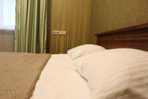 Postel nebo postele na pokoji v ubytování Bogdanov Yar Hotel