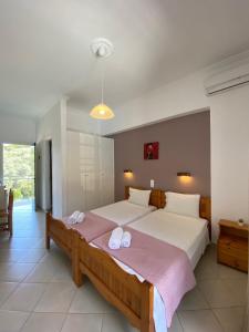 a bedroom with a large bed with towels on it at Anemona Studios in Paleokastritsa