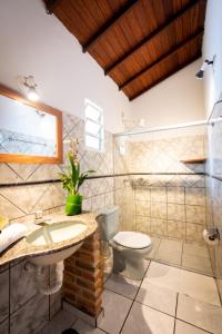a bathroom with a toilet and a sink at Pousada Por do Sol in Trancoso