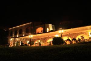 a large building with lights in front of it at night at Villa Govi in Diano Castello