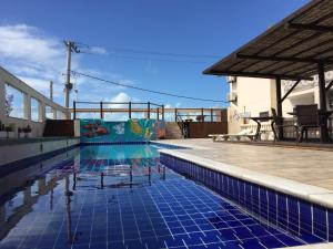 una piscina con suelo de baldosa azul en Eden Praia Hotel, en Porto Seguro