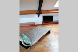 a room with a bed on a wooden floor at Arona 01 attic mansarda secondo piano no ascensore no hotel in Arona