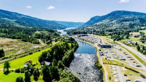 an aerial view of a road and a river with cars at Topcamp Hallingdal - Ål in Ål