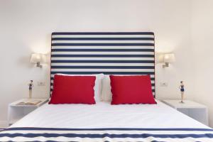 a bedroom with a large bed with red pillows at Gala Residence Villa Giovanna in Ravello
