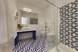a bathroom with a sink and a glass shower at Gala Residence Villa Giovanna in Ravello