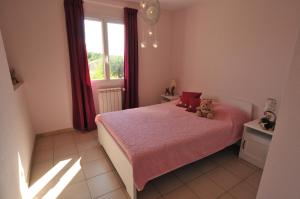 une chambre avec un lit rose avec un ours en peluche dessus dans l'établissement Gîte de Catherine, à Saint-Didier