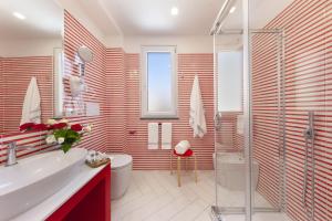 a bathroom with a sink and a toilet and a shower at Gala Residence Villa Giovanna in Ravello