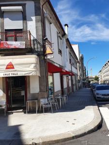 a street with tables and chairs outside of a building at Truz truz4 in Porto