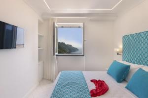 a bedroom with a bed with a red shirt on it at Gala Residence Villa Giovanna in Ravello
