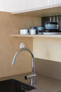 a kitchen counter with a sink and a faucet at CASA NO CASTANHEIRO in Meda