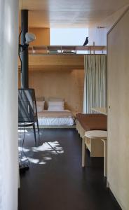 a bedroom with two beds and a tv in it at CASA NO CASTANHEIRO in Meda